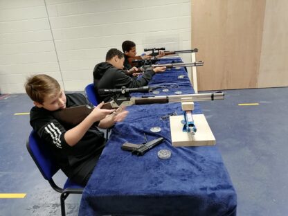 3 young people shooting airguns